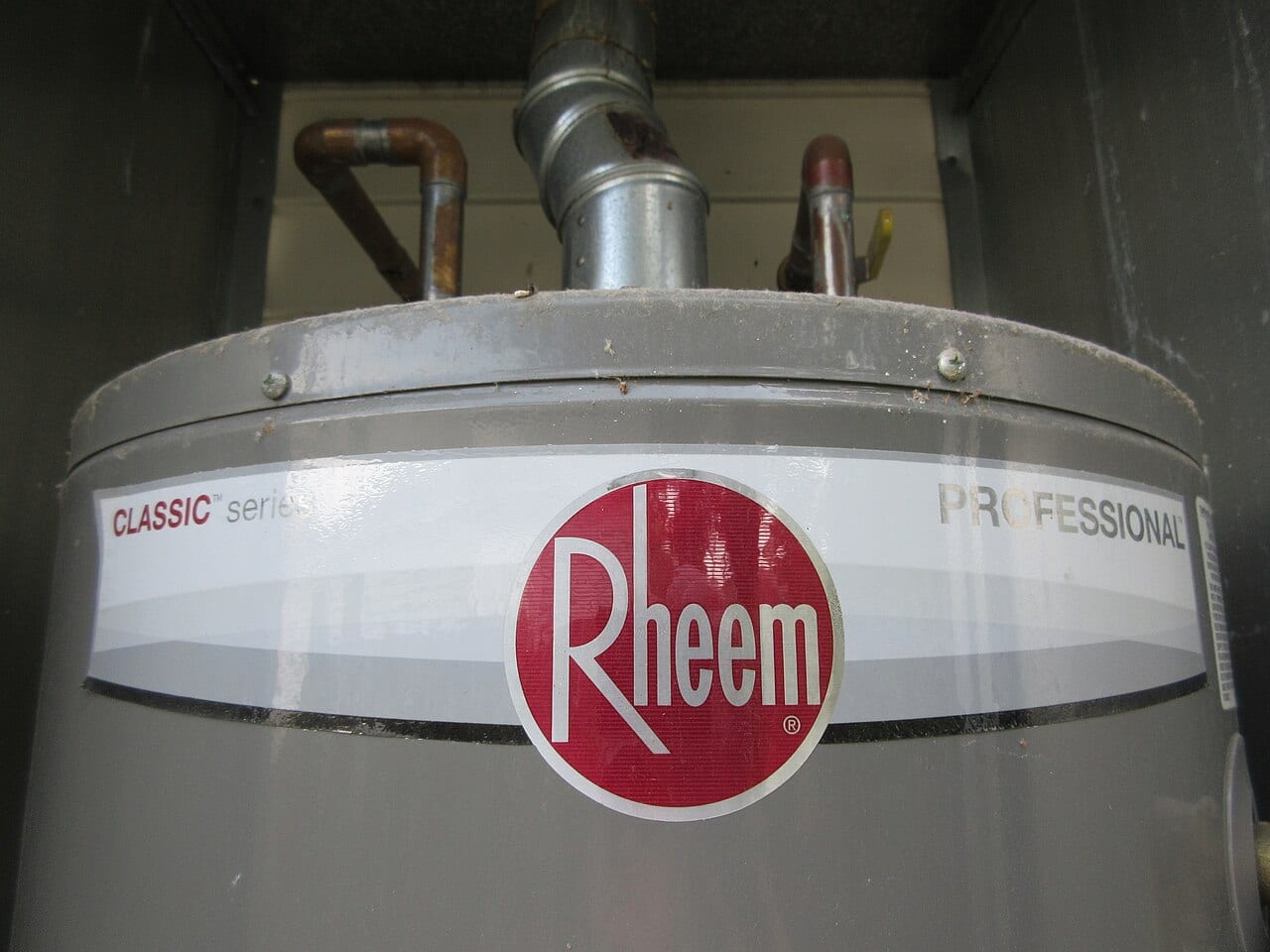 Storage water heater with supply connections and a vent